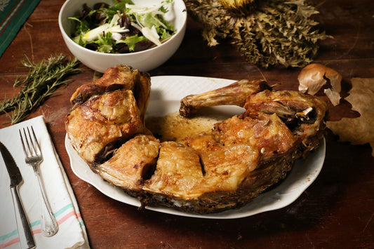 Roast lamb served with fresh salad on a rustic wooden table